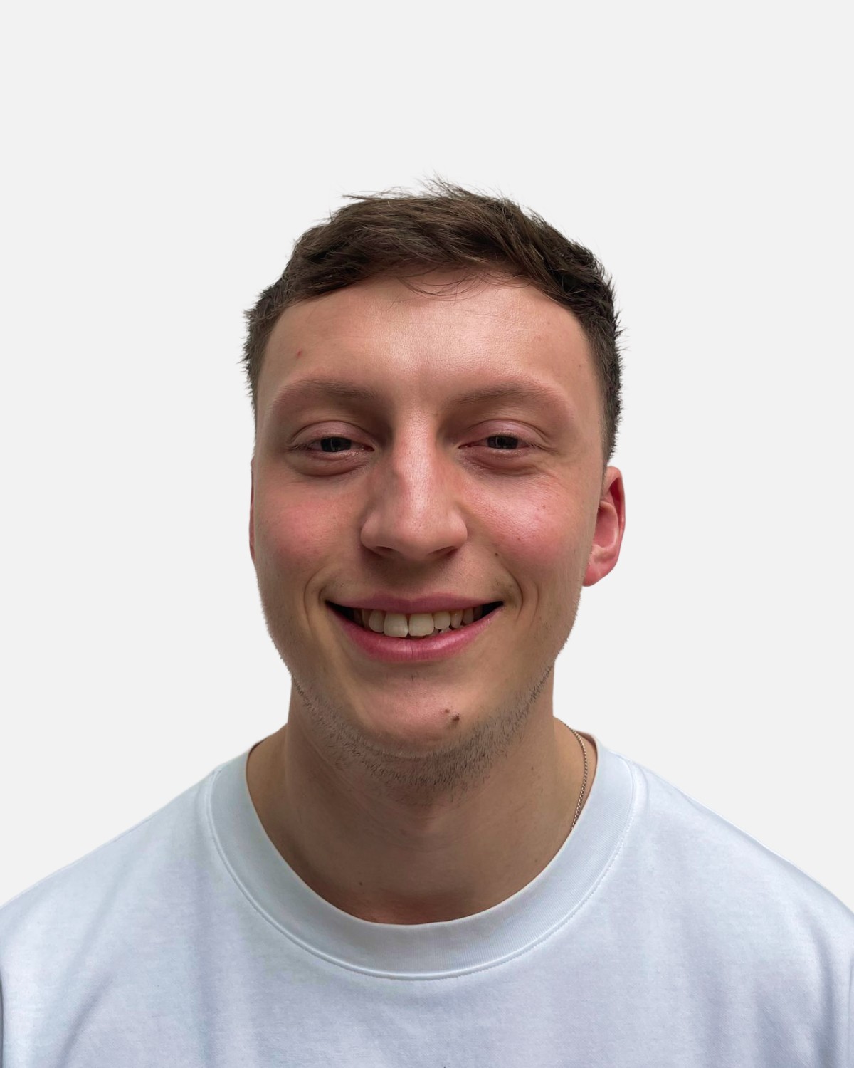 the portrait photo of a young and good-looking man, looking directly to the camera, wearing light shirt  , smiling to the camera