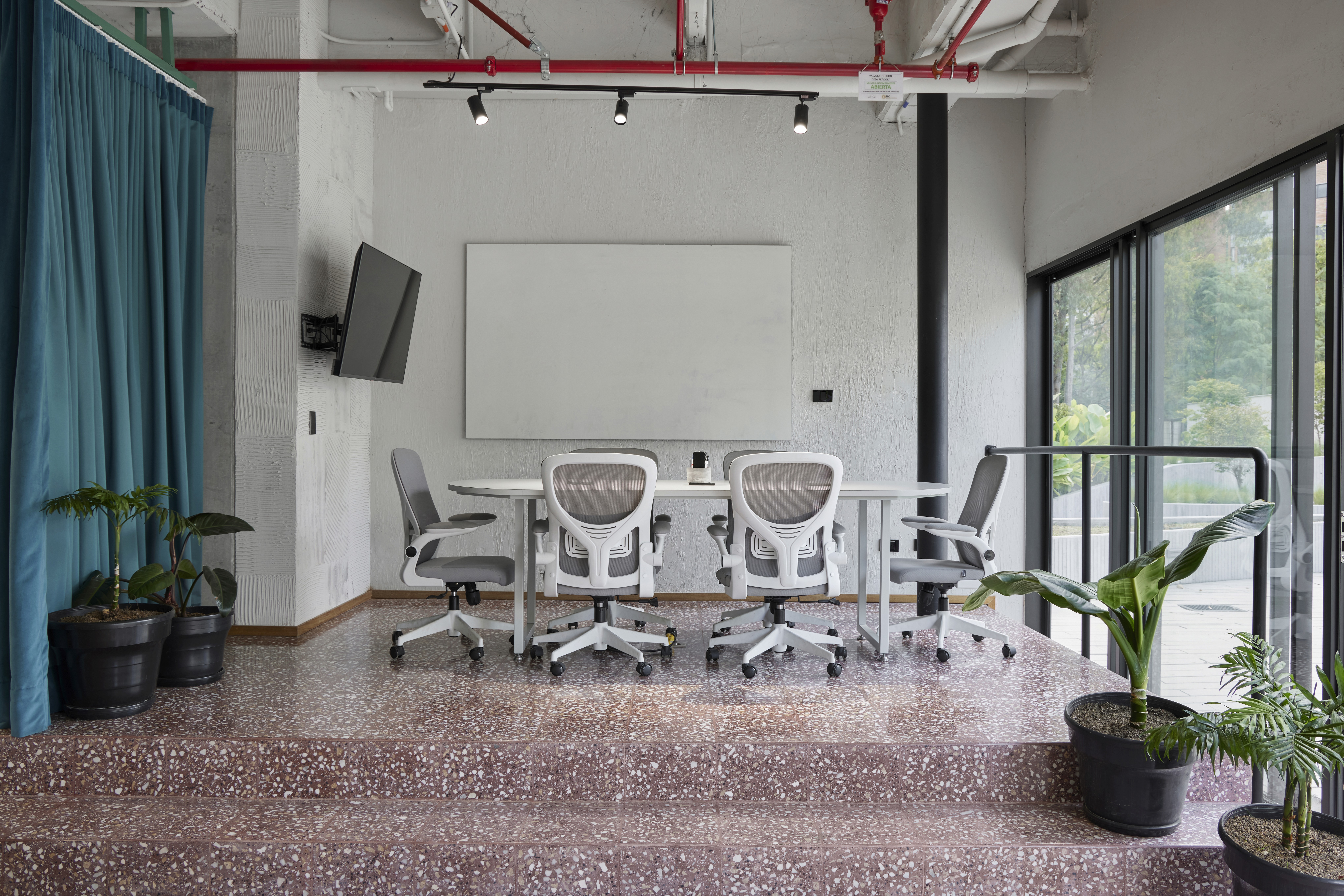 Double-height interior with flowing sculptural forms and warm raking light