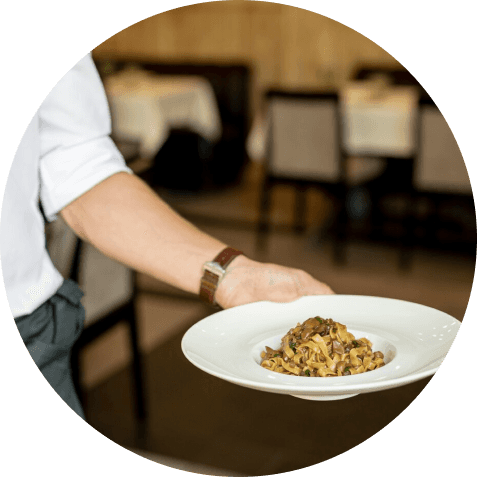 Waiter Holding Plate of Pasta