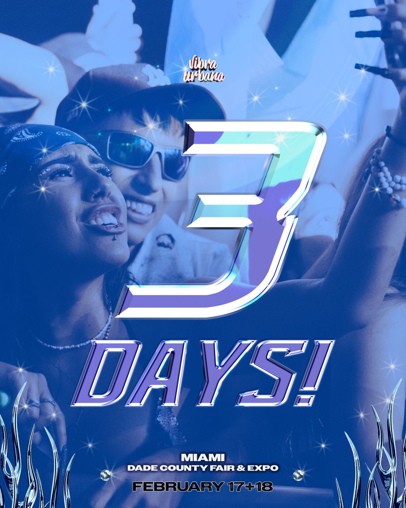 Close-up portrait of a person wearing a gray insulated hooded jacket with the hood up, showing their face framed by the hood against a light background.