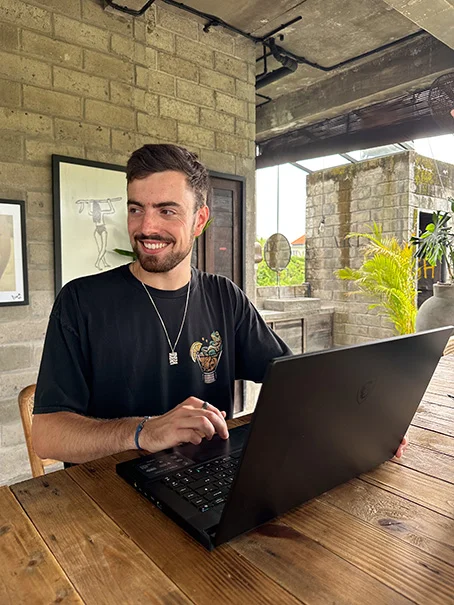 photo of the founder smiling working in a cafe