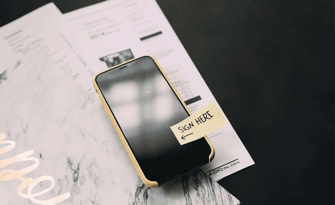 Mobile phone with a message to 'Sign here'
