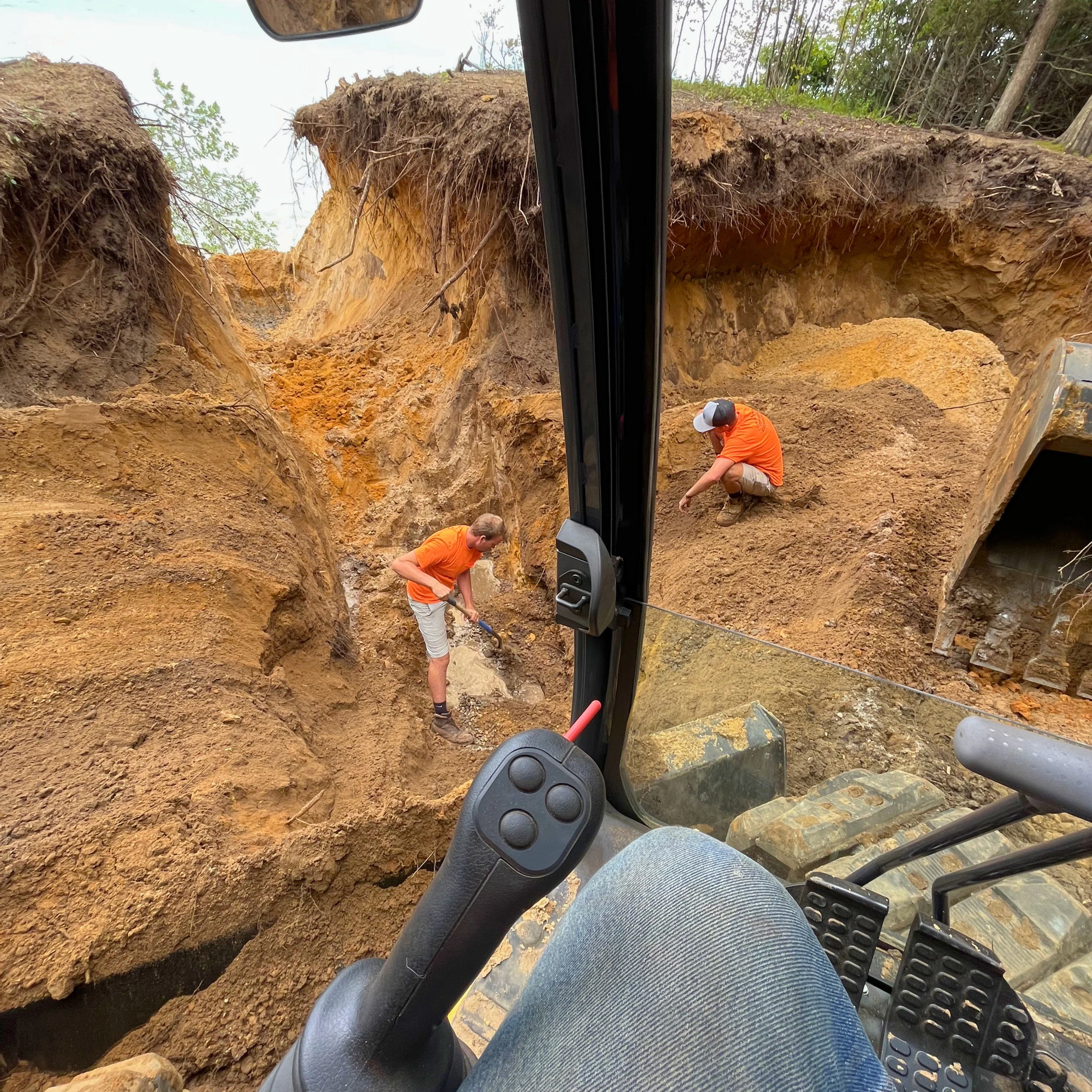 yellow and black excavator on brown soil