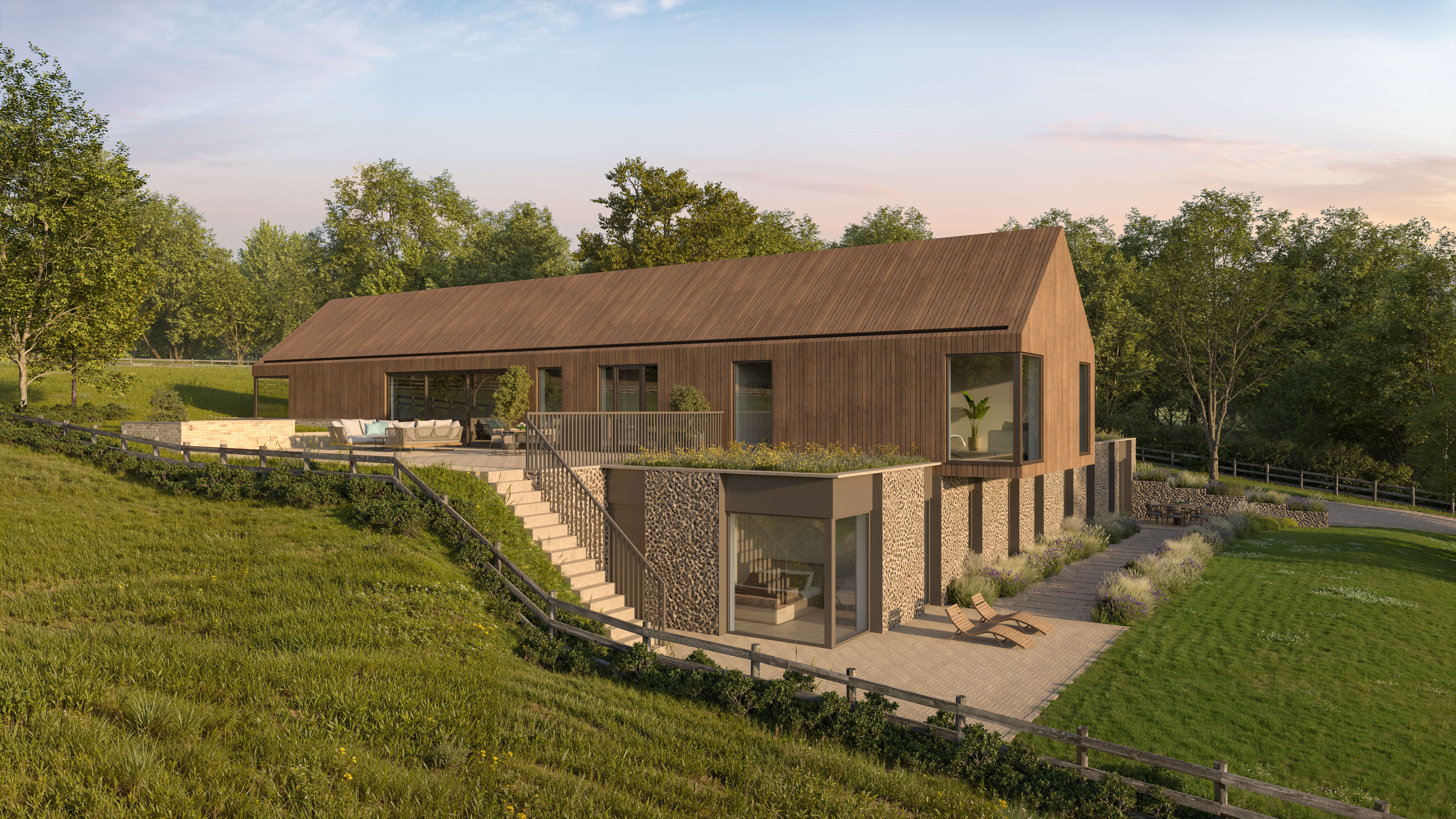 The Arch’s timber-clad upper floor above flint walls and a garden terrace