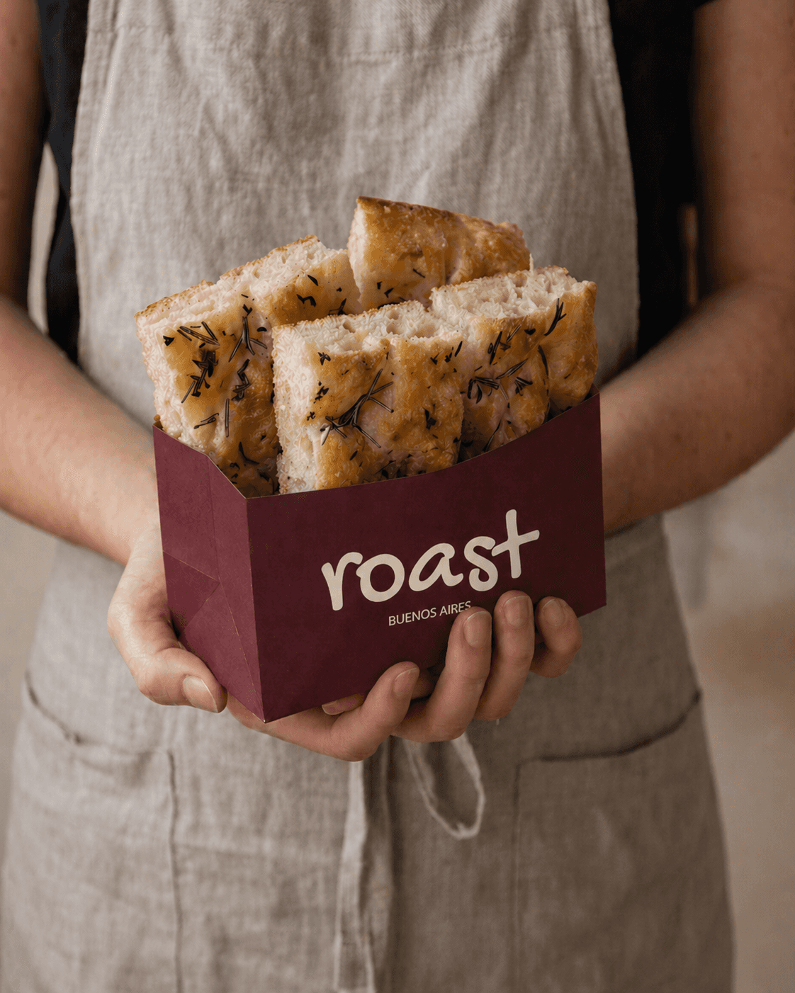 Clear skincare bottle with pink cap, bi-phase serum and floating bubbles on a white backlit background.