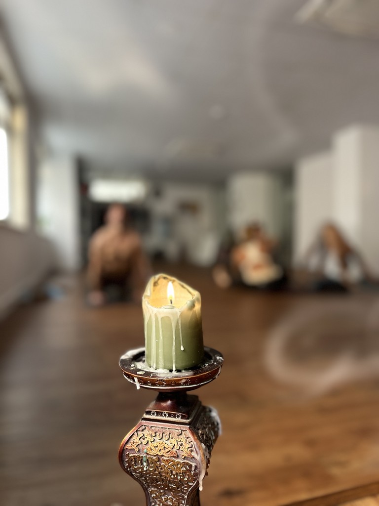 Shirtless man meditating indoors