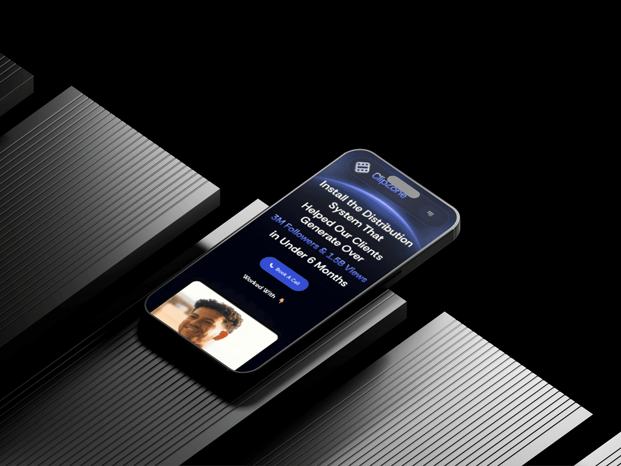 A smartphone displaying a sleek, dark-themed application interface with a prominent call-to-action button is placed atop black, ribbed platforms, emphasizing technology and innovation.