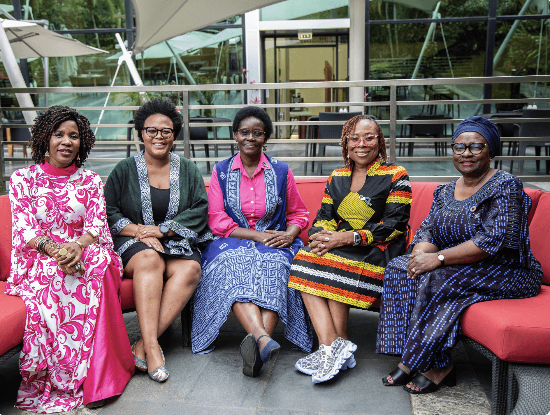 From left to right: Dr Miriam Mutebi, Dr Kgothatso Motumi, H.E. Dorothy Nyong'o, Karen Nakawala Chilowa and Dr Magda Robalo, members of the Africa Breast Cancer Council, seated together on a red outdoor sofa.