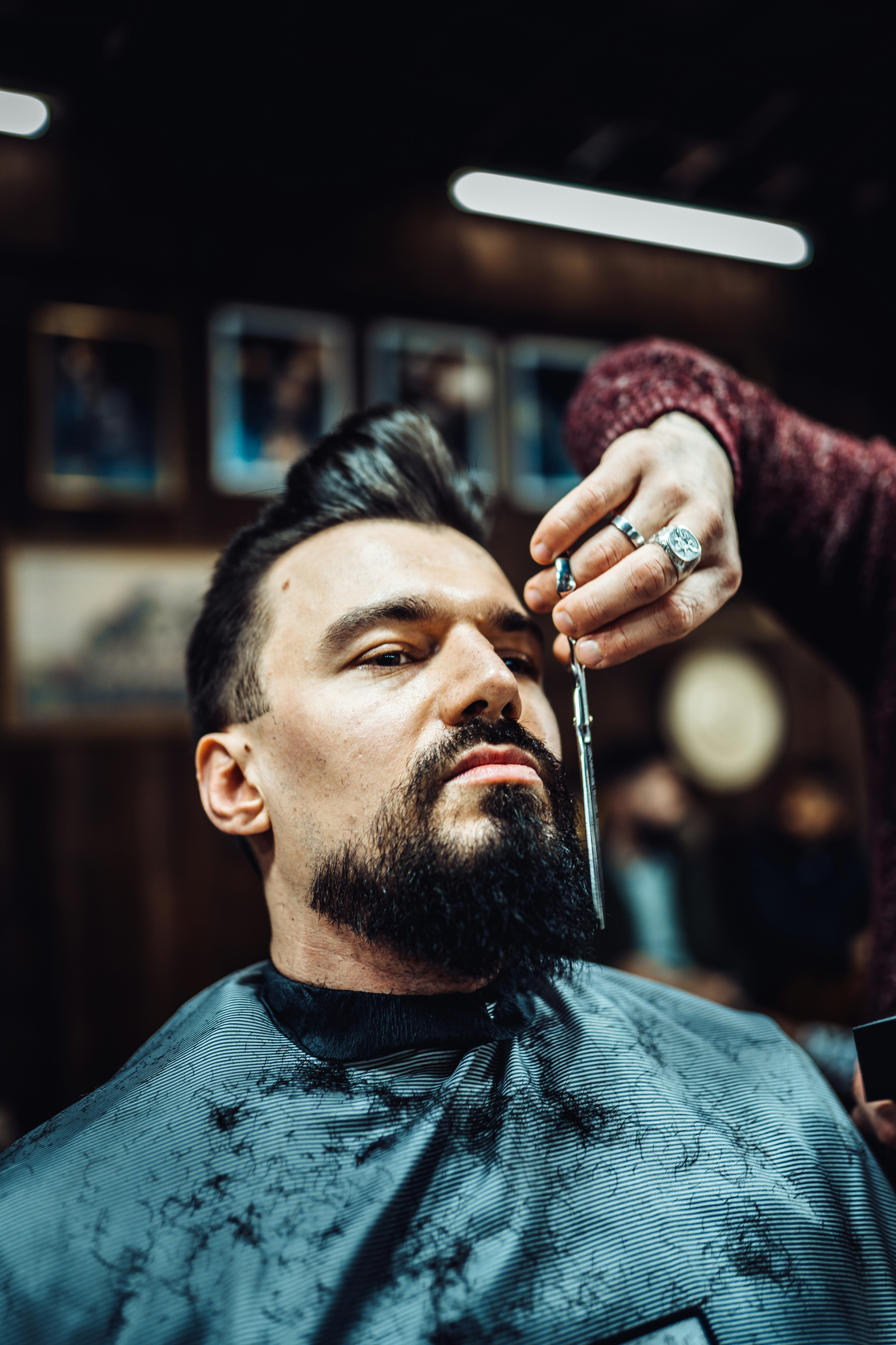 a man getting his hair cut at a barber shop