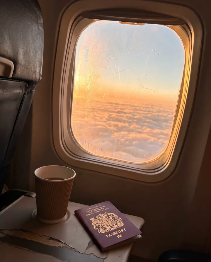 Sunrise over the clouds from an aeroplane window