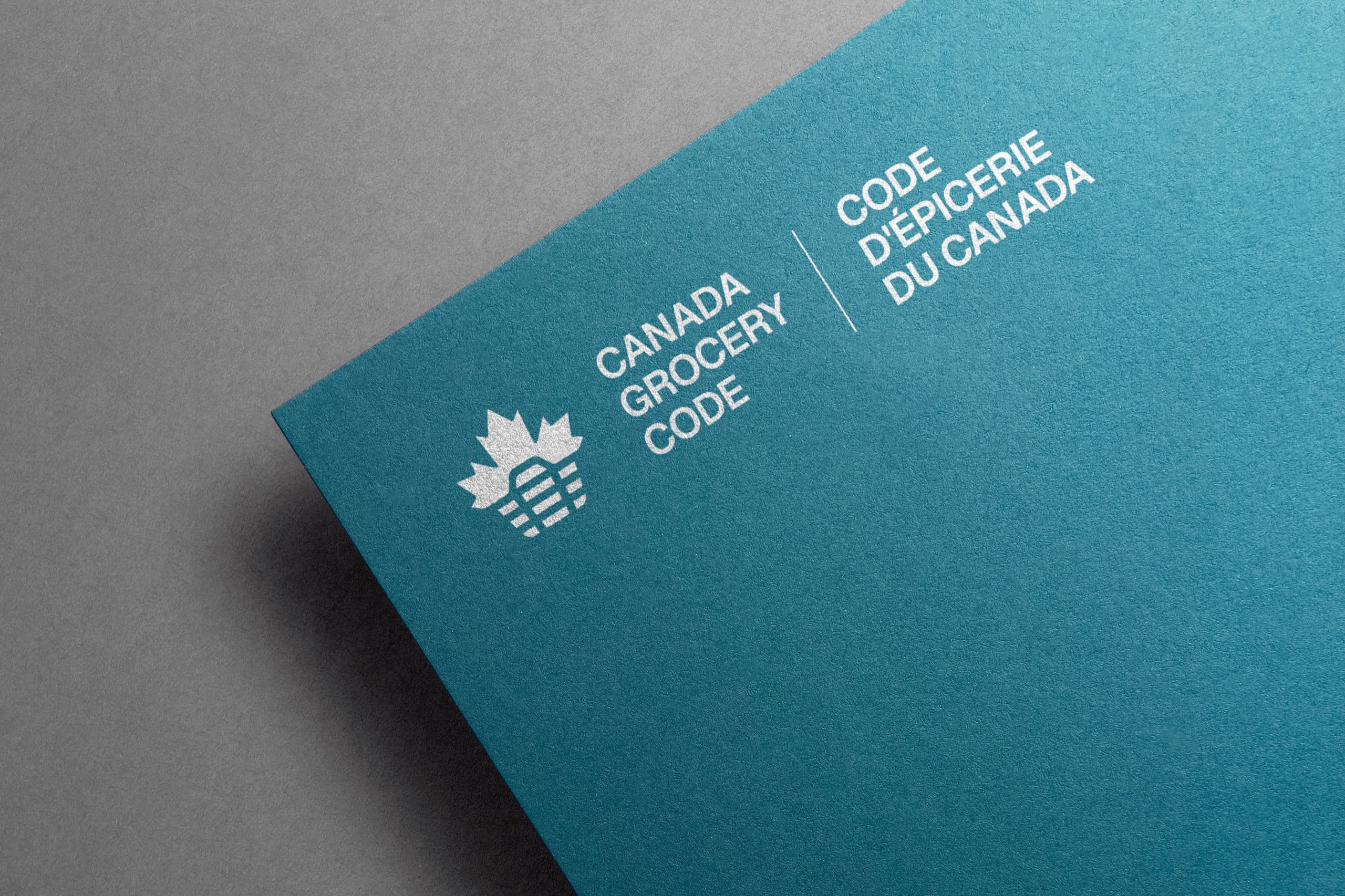Canada Grocery Code logo rendered on a kit folder.