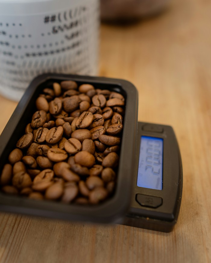 Roasted beans weighed in a tray on brewing scales