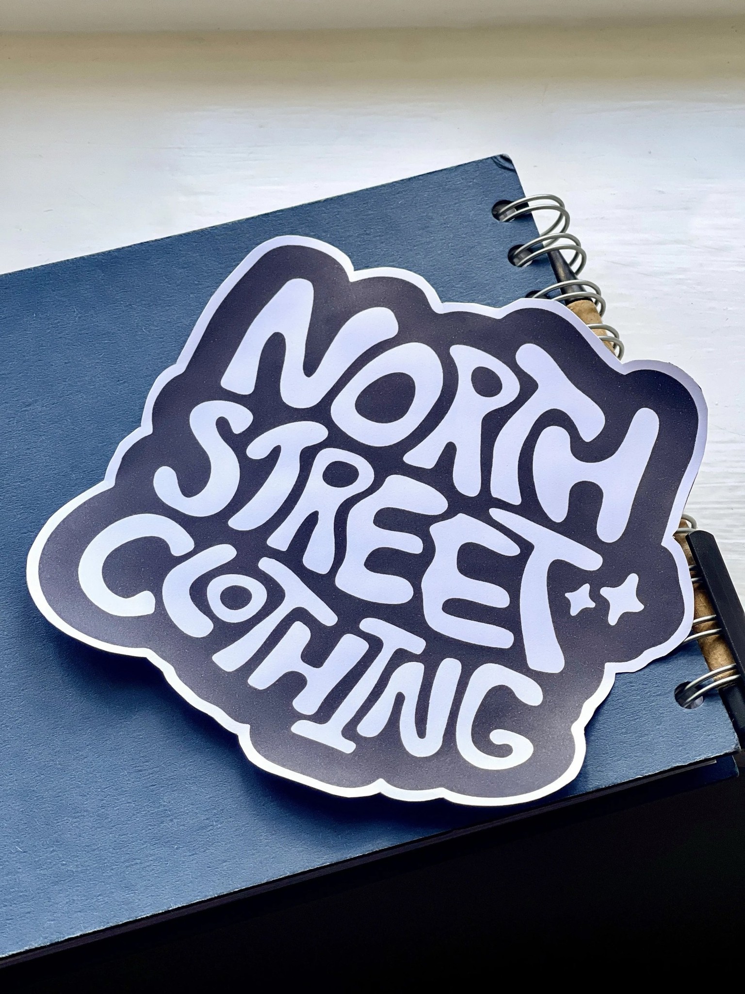 North Street Clothing sticker on a notebook