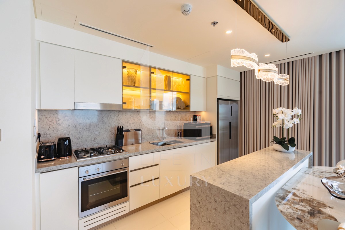 Discover the elegance of this kitchen, featuring a stylish stainless steel oven, gas cooktop, and other modern appliances.