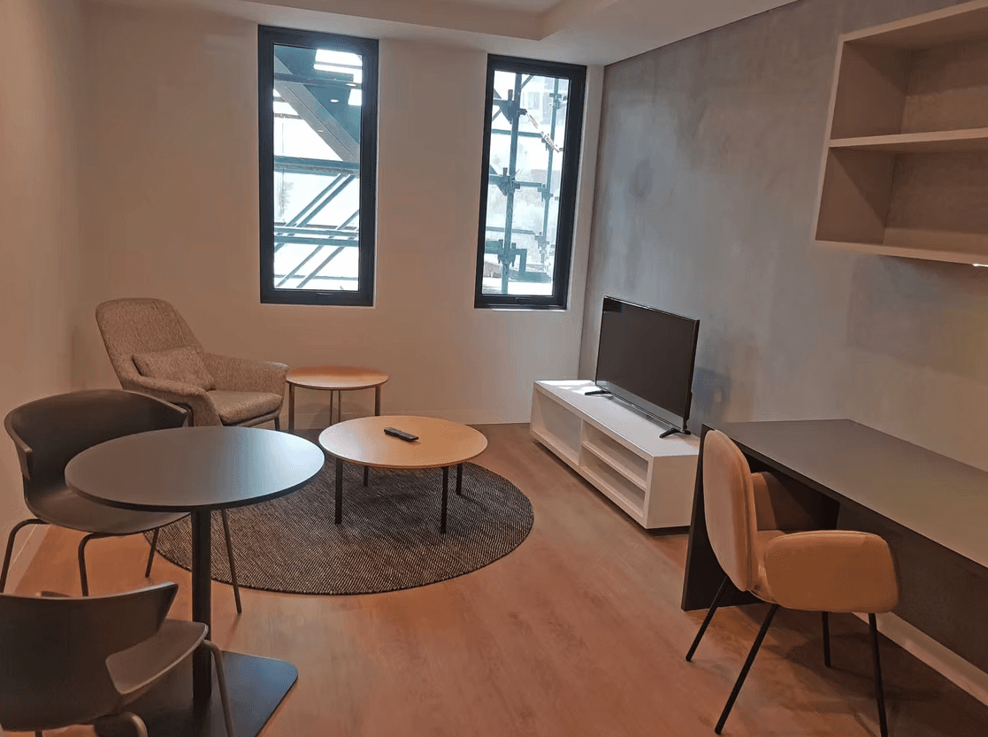 a living room with two recliners and a sink