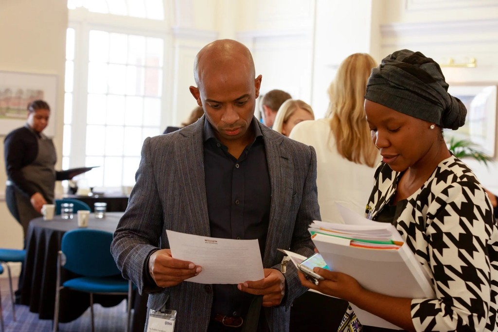 Hosh Ibrahim reviewing a press release with Sophie Matsipa and Foundation colleagues