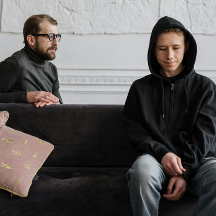 A psychiatrist taling to a teenager