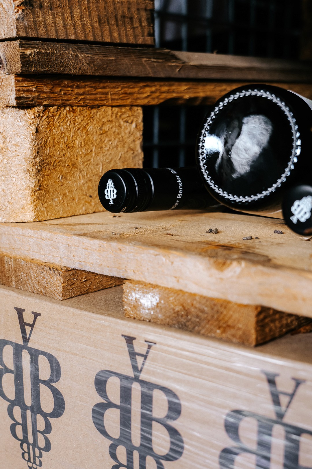 Close-up of wooden pallets with black objects on them, on which a logo is clearly visible.