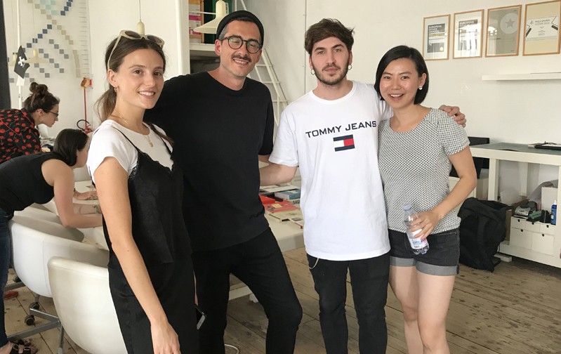 A photo of a group of people standing in an art gallery.