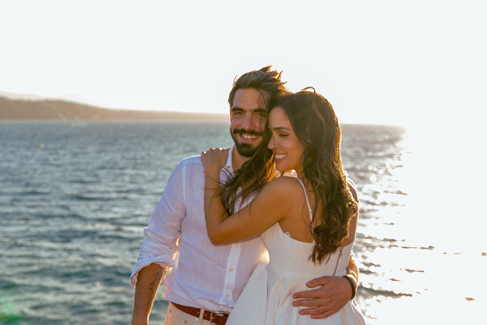 Couple portrait with dog on field