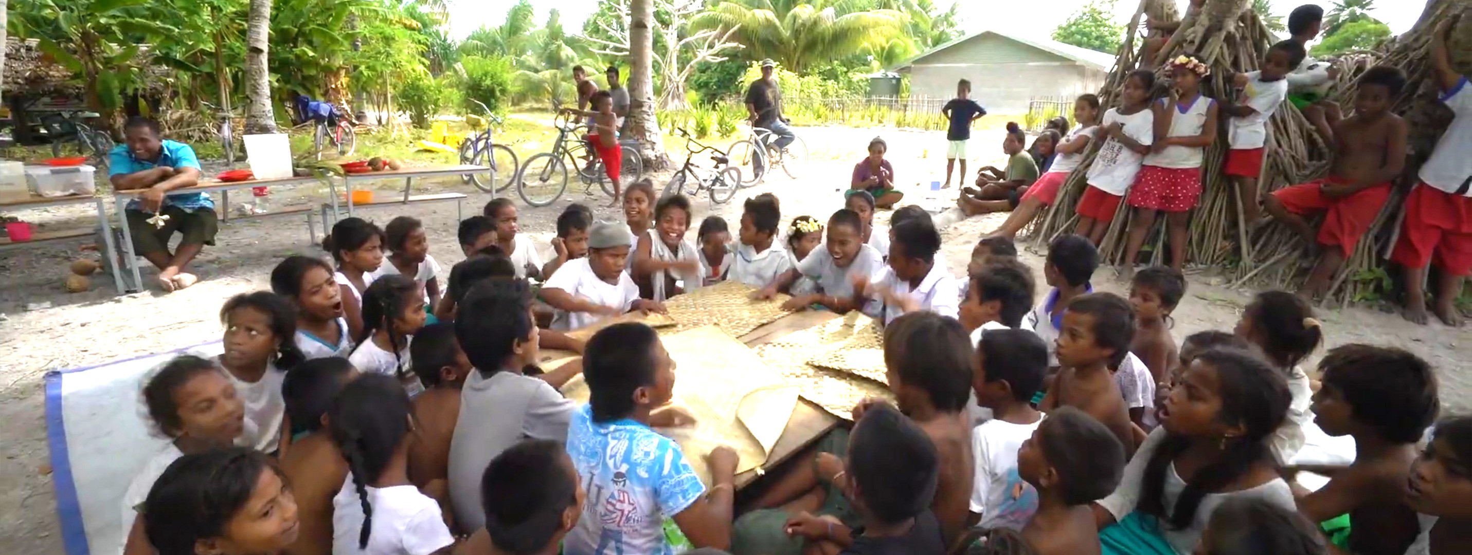 woman holding a phone and man looking at the phone. both are smiling