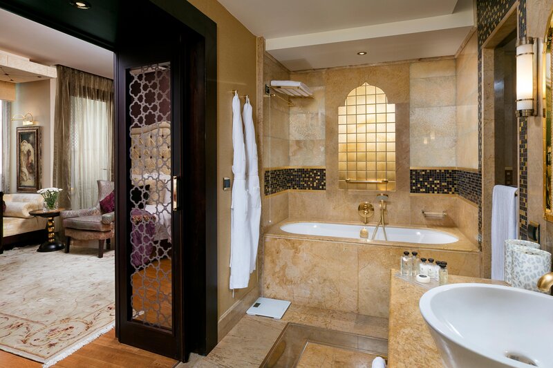 Bathroom with shower or bathtub, makeup mirror, hair dryer, scale, and branded amenities.