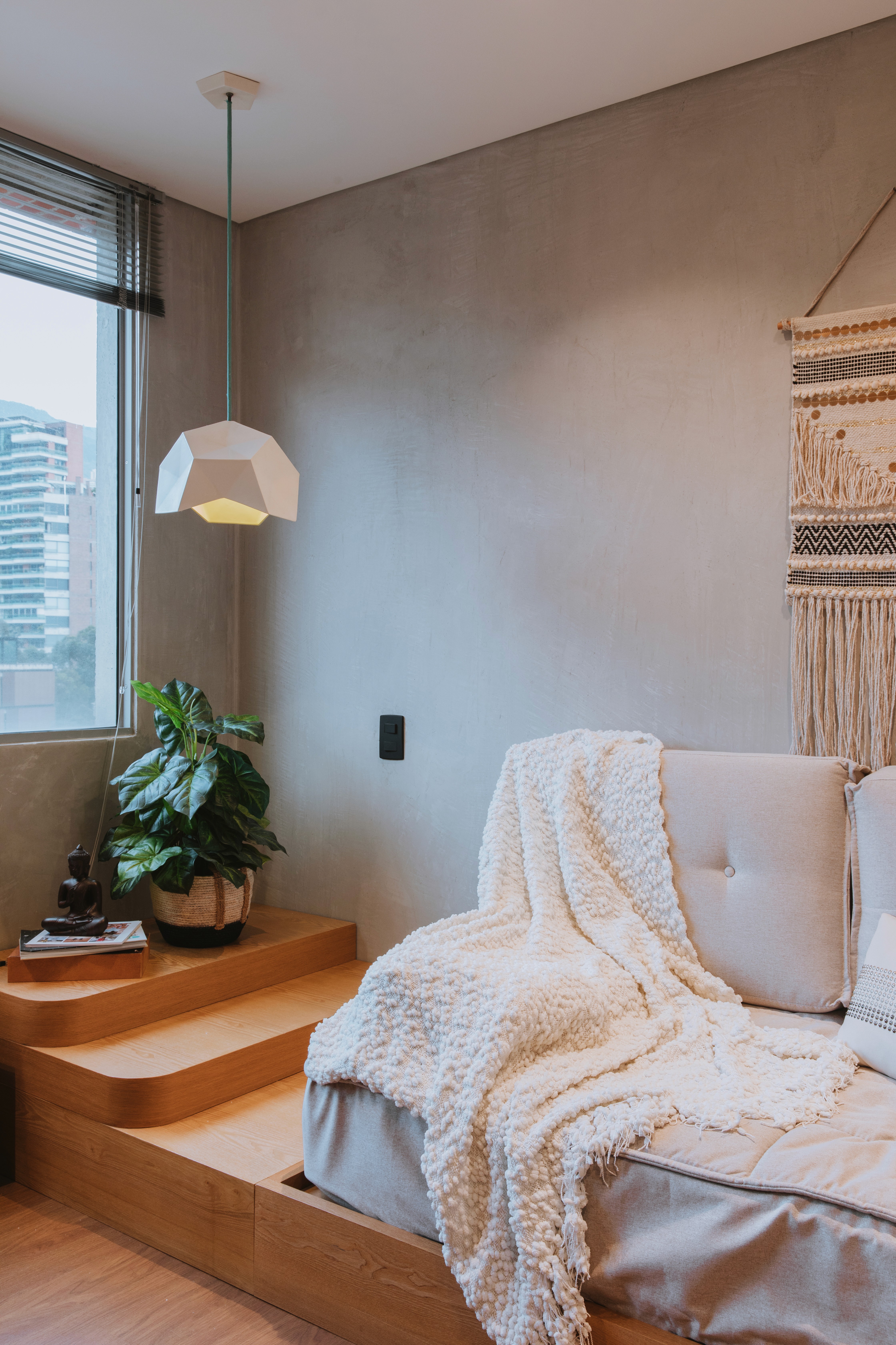 Double-height interior with flowing sculptural forms and warm raking light