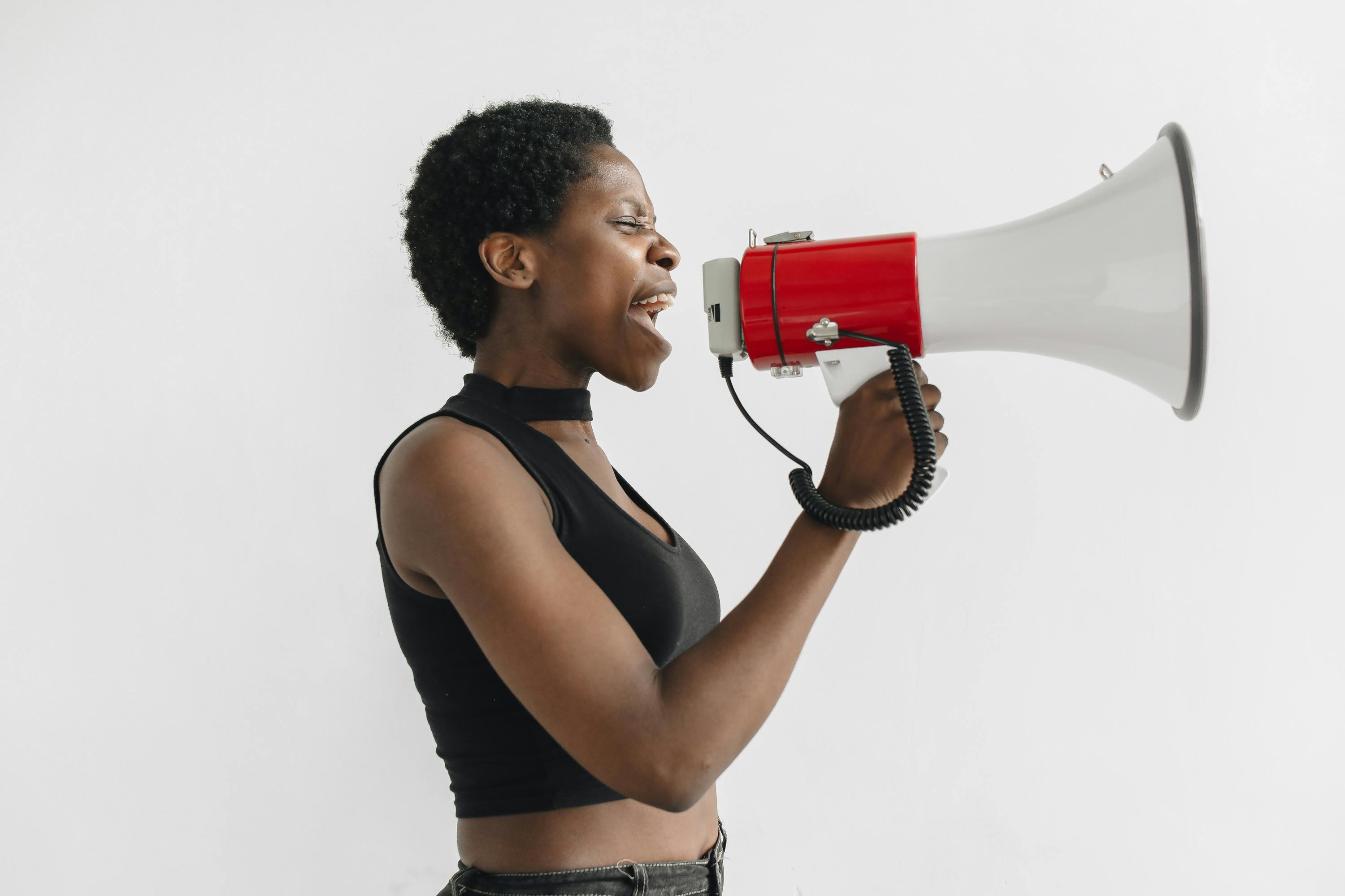 A black female holding a bullhorn, making an announcement