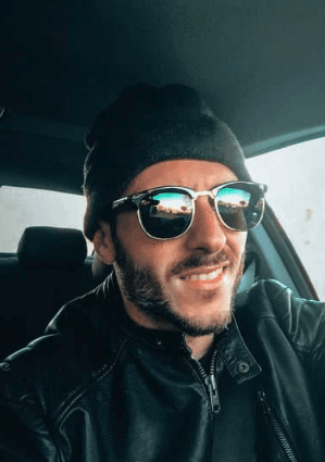 A woman relaxing in soft sunlight, surrounded by plants and warm decor, emphasizing the peaceful and rejuvenating experience of the spa.