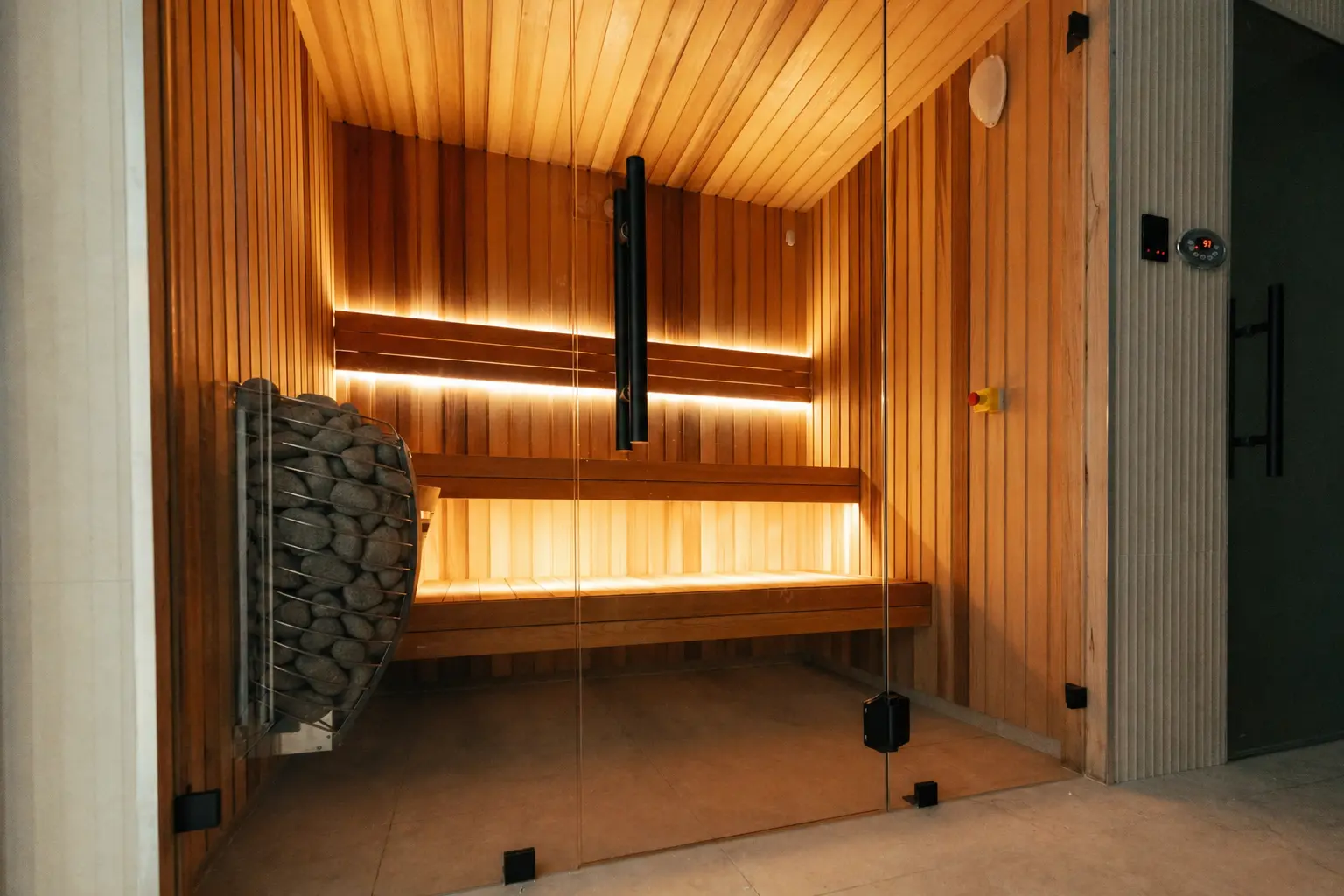Man relaxing on a wooden bench in a sauna.