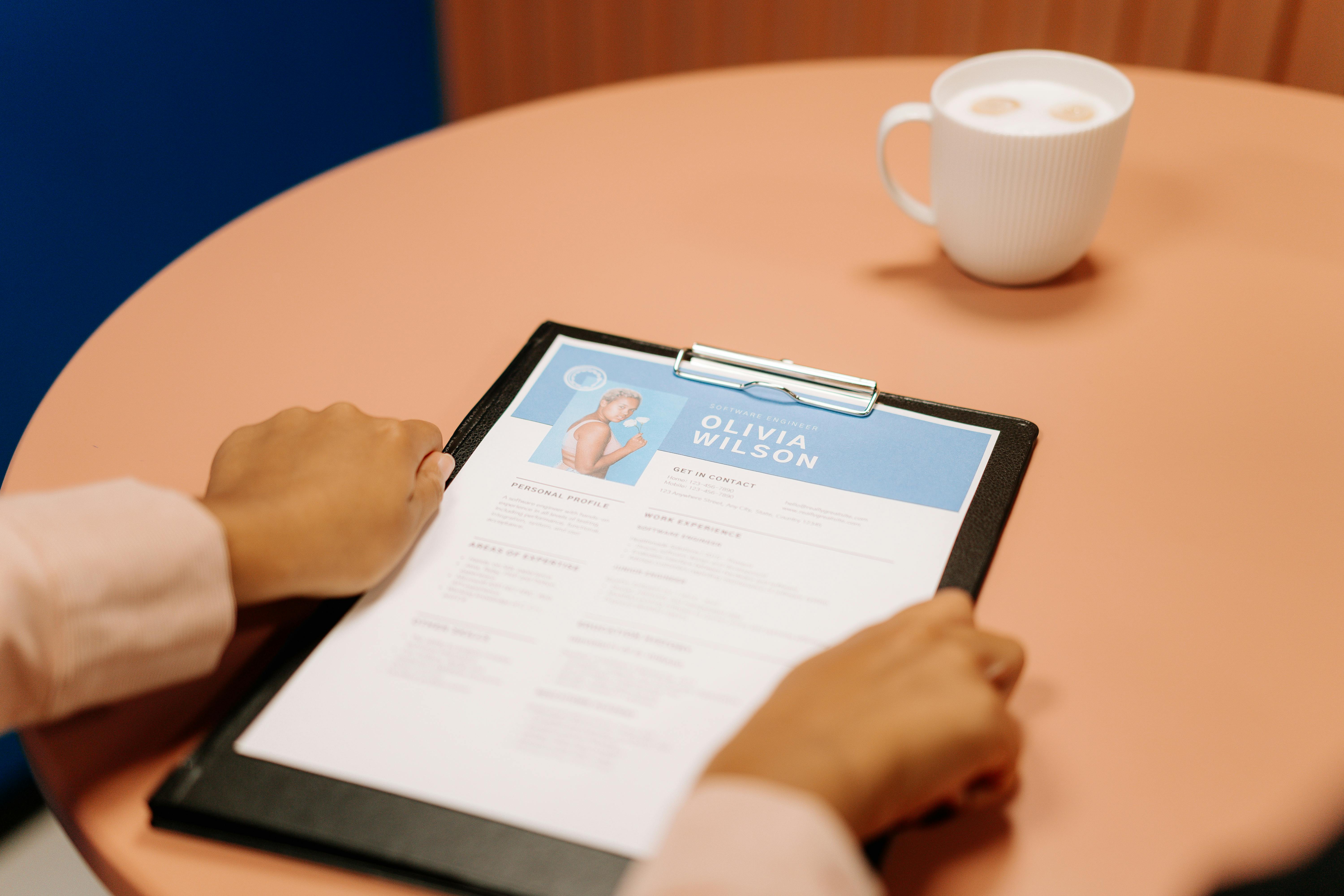 Resume on a table during an interview, representing thoughtful preparation and unique interview questions to ask employers.