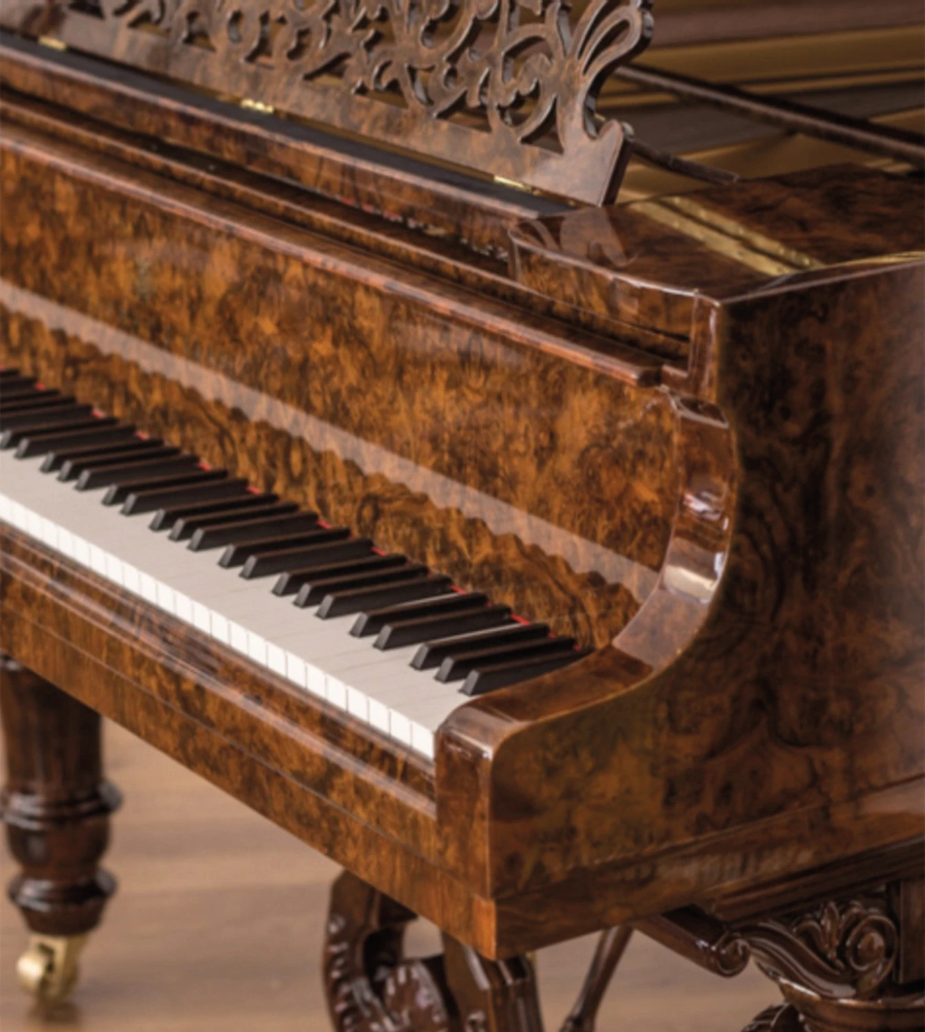 Detailed view of the hand-carved music stand with delicate ornamental patterns and a lyre motif.