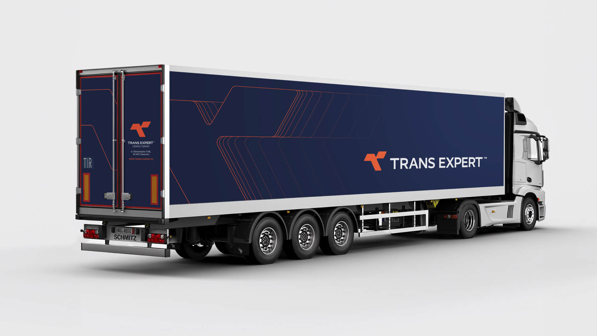 Rear view of a semi-truck trailer branded for Trans Expert. The trailer features a large navy blue surface with the white company logo and an orange line graphic, highlighting the consistent corporate design.