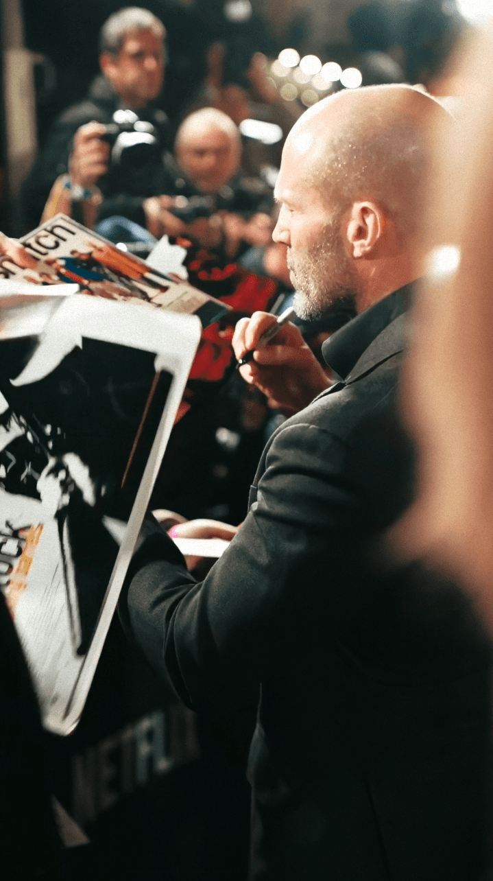 Dancer in black outfit with one leg raised behind