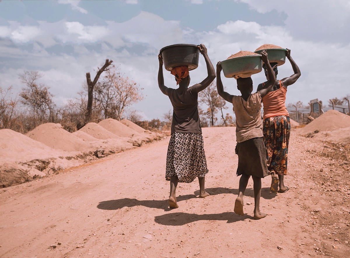 Women carrying basins while walking