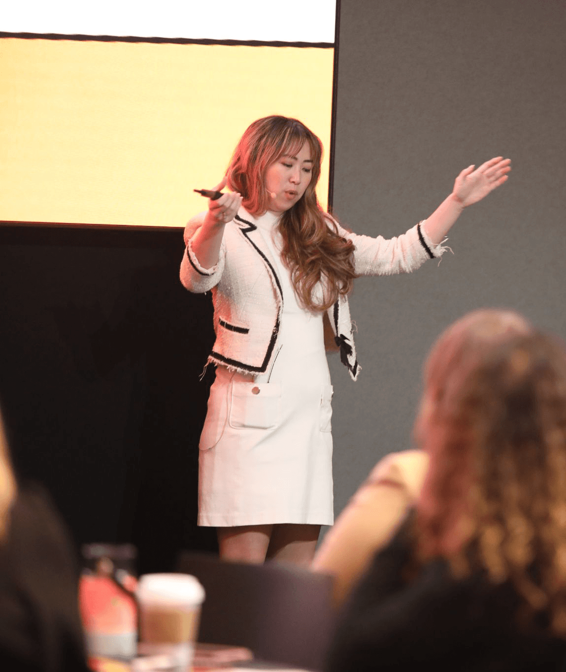 Modern terracotta architecture studio with curved ceilings, grid windows, round tables, stools, plants, and a contemporary chandelier.