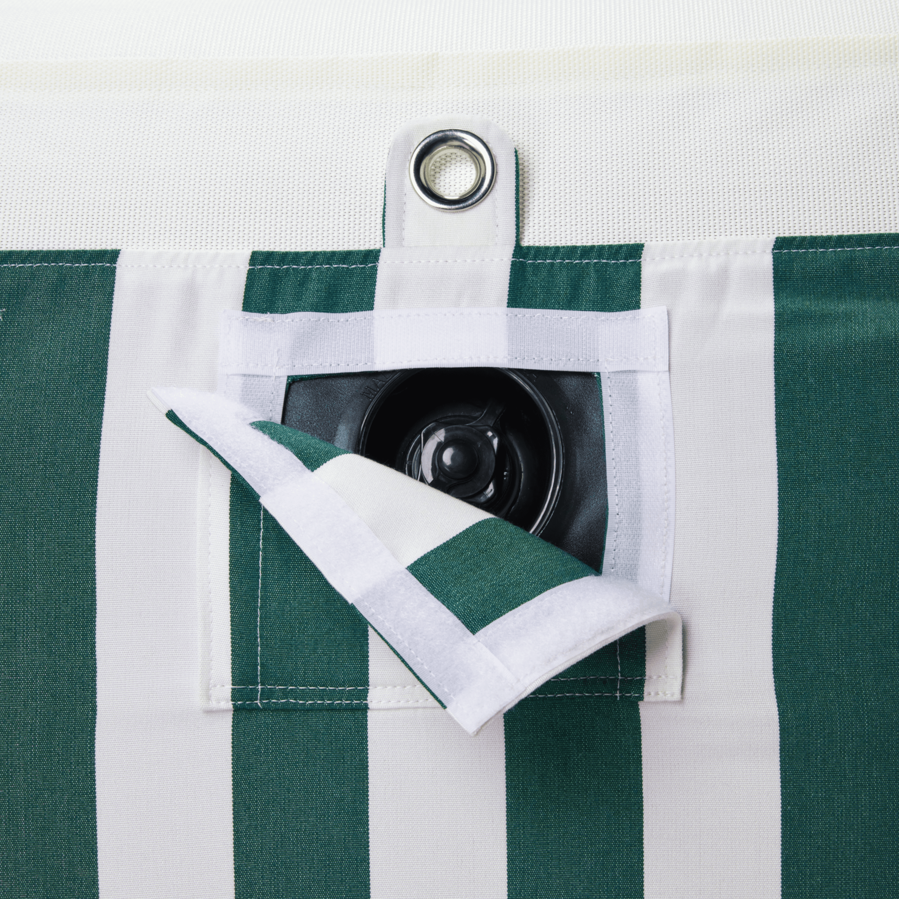 Close-up of pool float showing green-and-white canvas, inflation valve, and matte white zipper