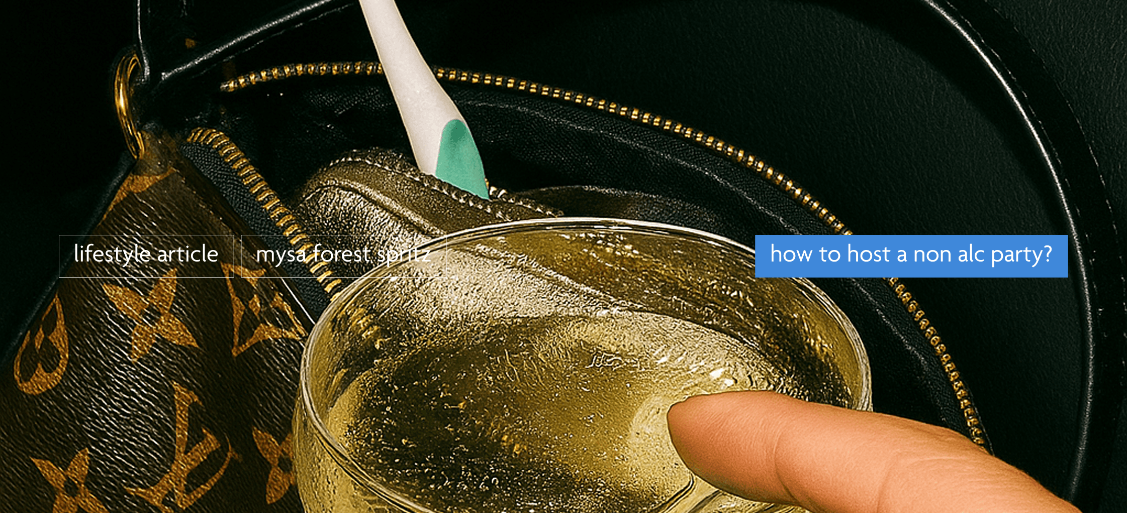 mysa yellow liquid in a coupe glass next to a louis vuitton purse in the car