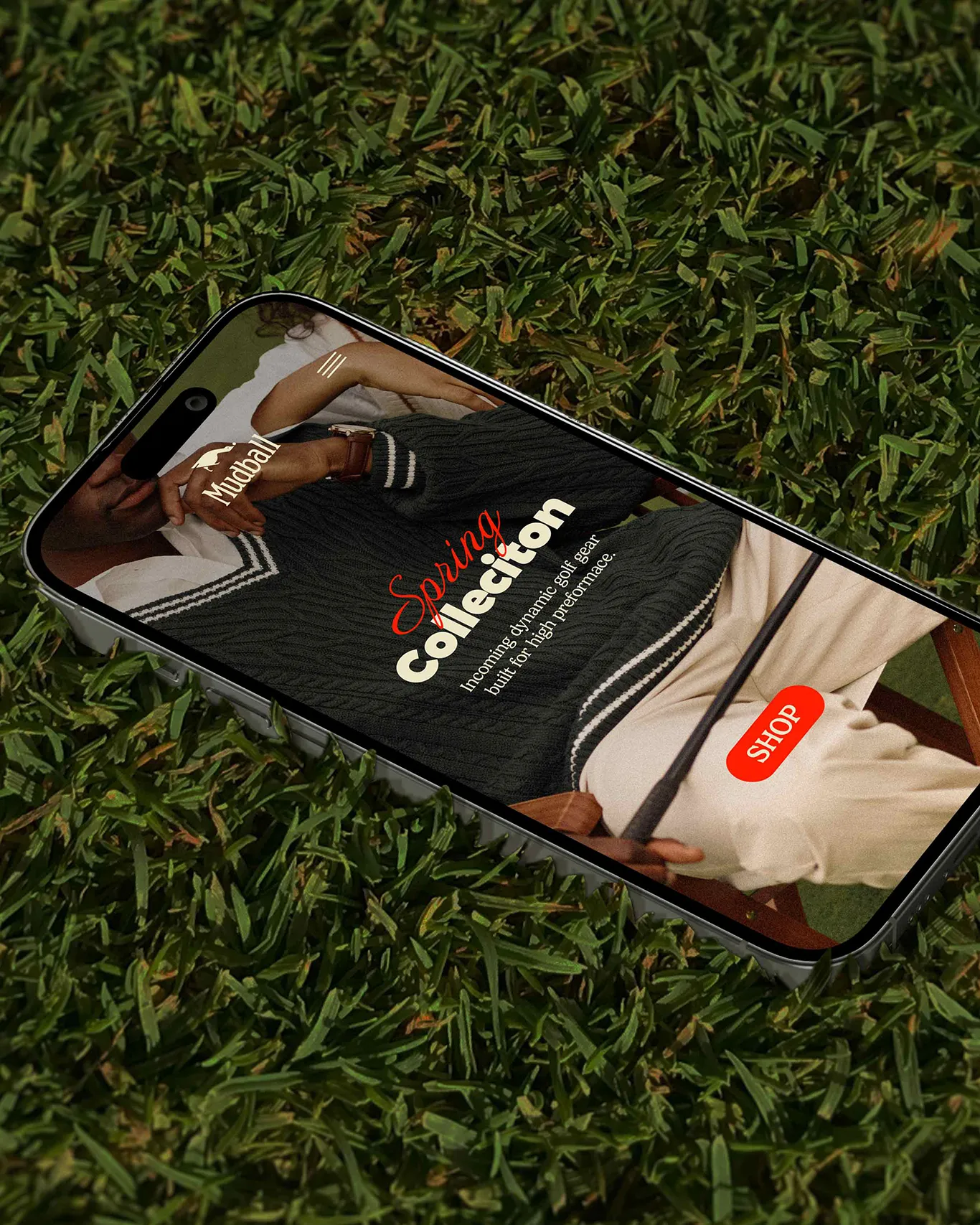 Smartphone displaying a branded apparel campaign mockup on grass
