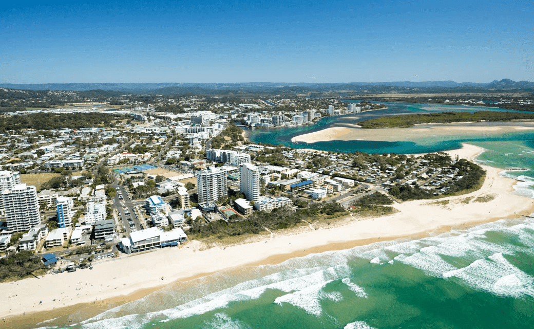 Coastal town with beach, buildings, and river delta