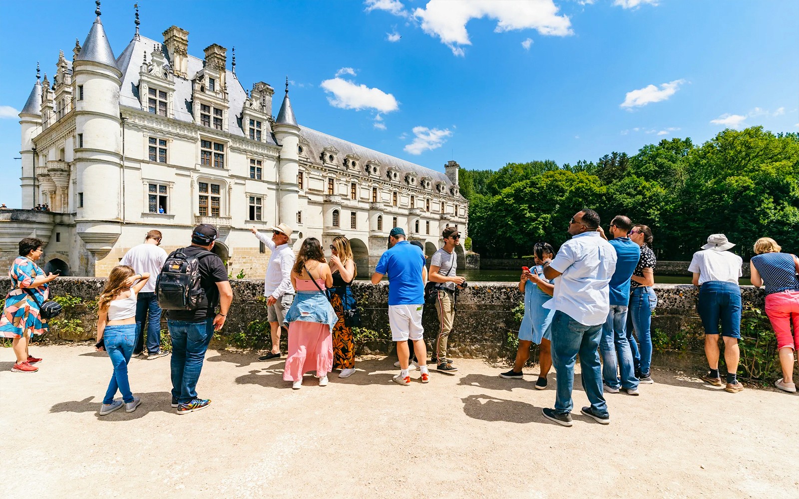 Group of tourists with a guide at Chambord Castle, France.