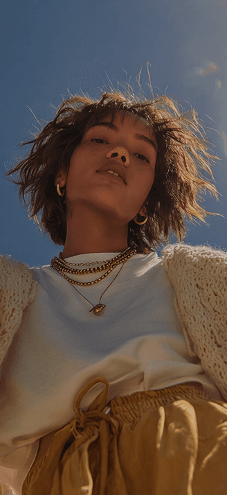 Person reaching toward camera against blue sky — editorial mood photo