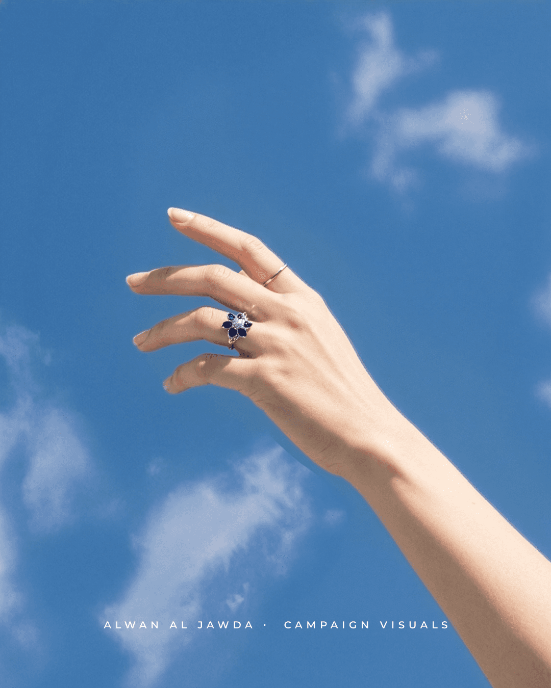 Close-up of a yellow tennis ball sitting on a green court, positioned near the white center line.