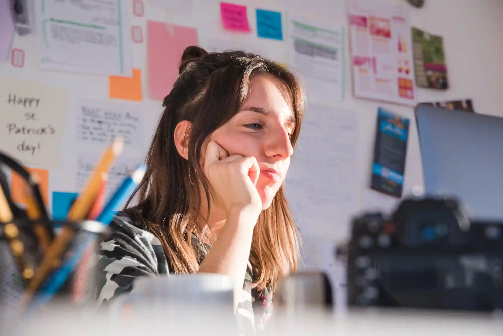 Creator focused on her laptop reviewing TikTok Shop earnings or planning her next product video.