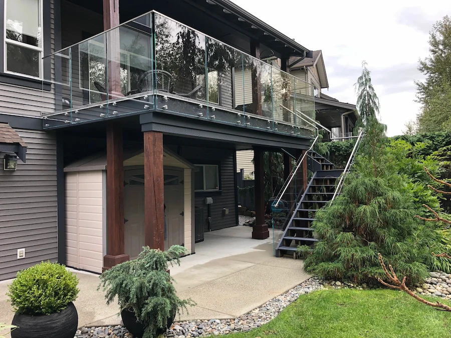 Elevated residential deck with frameless glass railing system in Victoria BC.