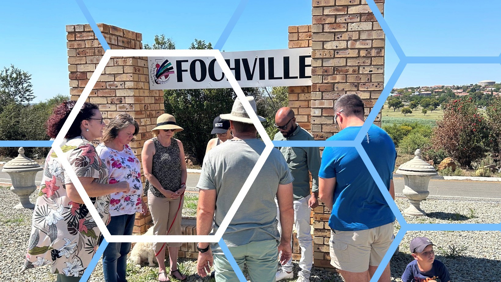 group of women in red and white dress standing on brown wooden bar during daytime