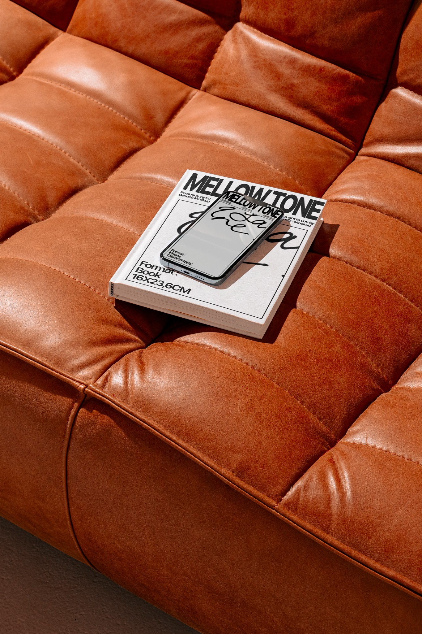 Stack of modern books and magazine with minimalist cover design on leather chair