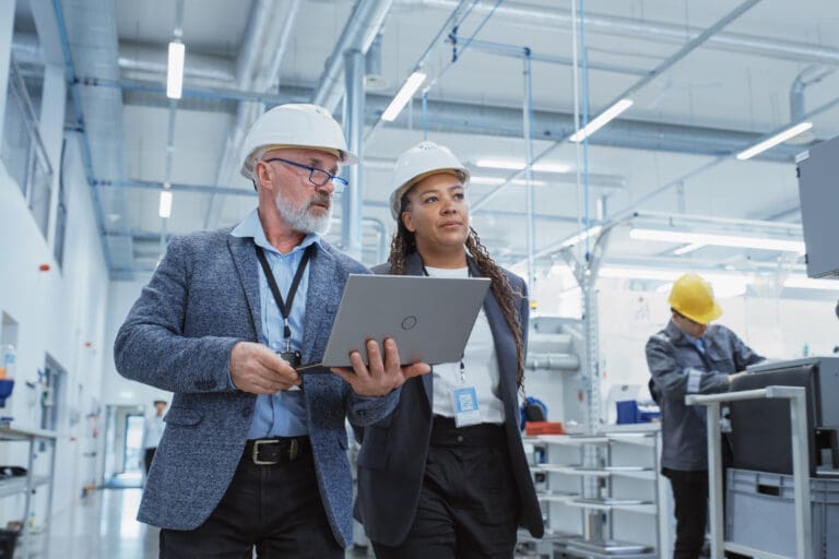 Workers walking through warehouse facility.