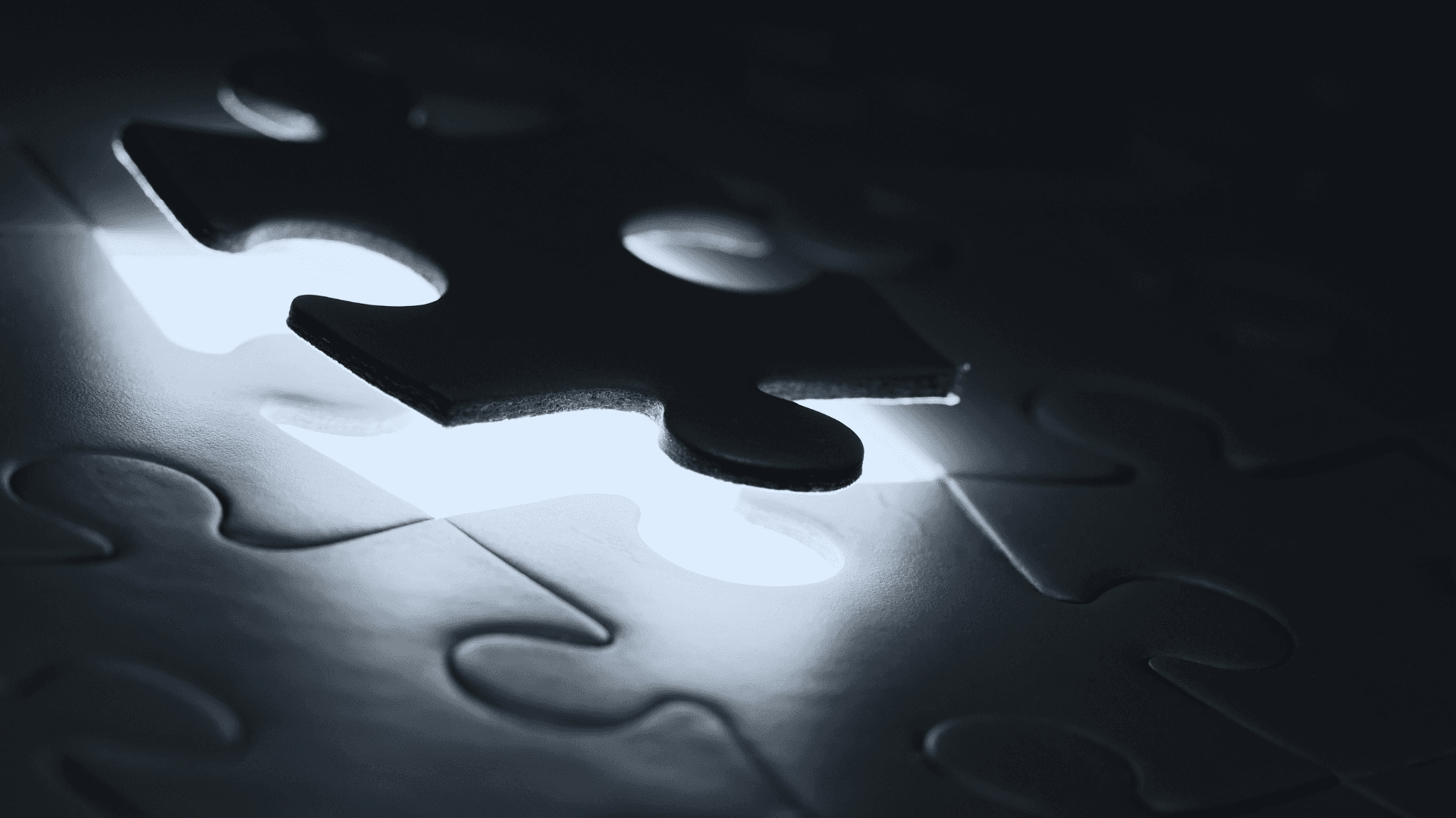 A backlit puzzle piece sliding into place