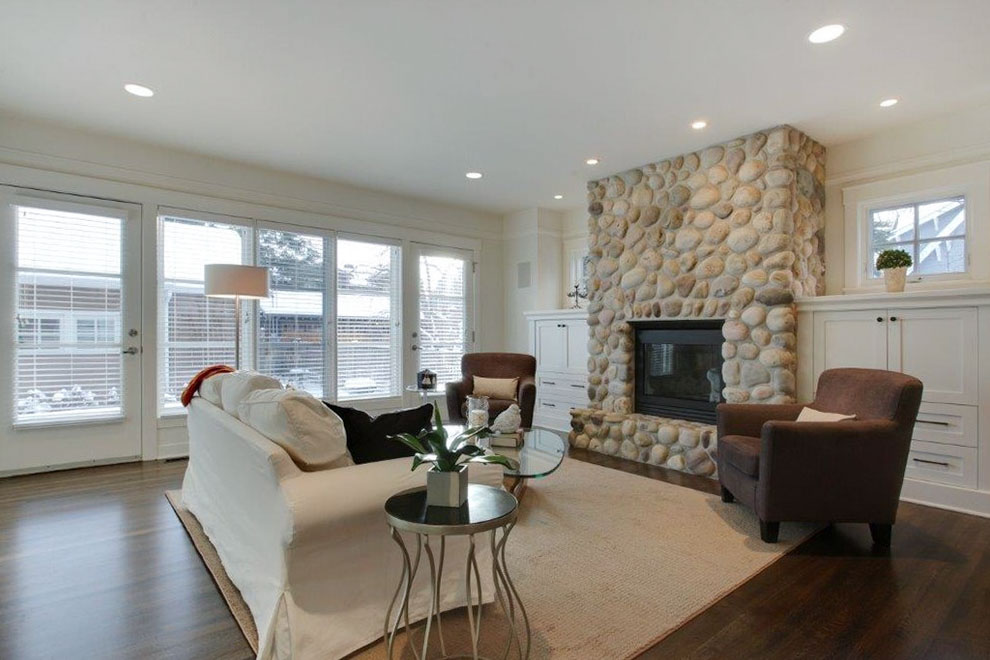 Image of Luxury living room interior design featuring KHD Homes design-build construction with stone fireplace and furniture.
